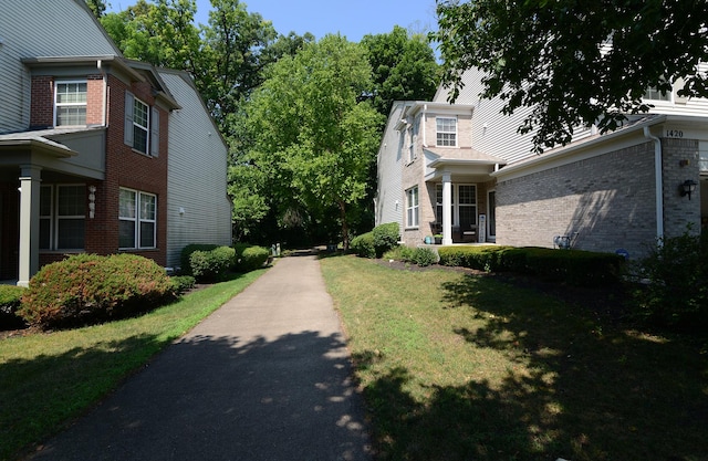 1420 Yellowstone Dr, Streamwood, IL 60107 - view of side of property featuring brick siding and a lawn