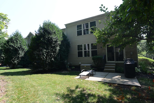 1420 Yellowstone Dr, Streamwood, IL 60107 - back of house with a patio and a lawn