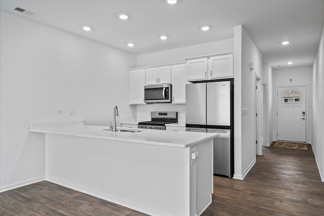 927 Darwin St, North Aurora, IL 60542 - kitchen featuring stainless steel appliances, dark wood finished floors, recessed lighting, white cabinetry, and a peninsula