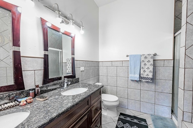1918 W Cermak Rd Unit 4, Chicago, IL 60608 - full bath with tile walls, double vanity, a shower stall, tile patterned floors, and wainscoting