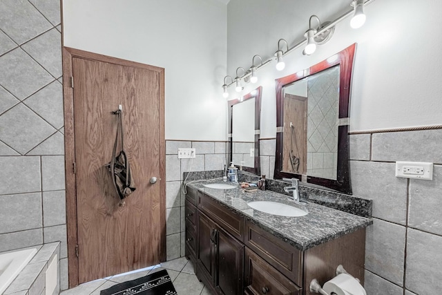 1918 W Cermak Rd Unit 4, Chicago, IL 60608 - full bath featuring tile walls, double vanity, tiled tub, tile patterned floors, and a wainscoted wall