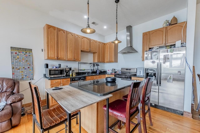 1918 W Cermak Rd Unit 4, Chicago, IL 60608 - kitchen with wall chimney exhaust hood, stainless steel appliances, light wood-type flooring, a kitchen bar, and a center island