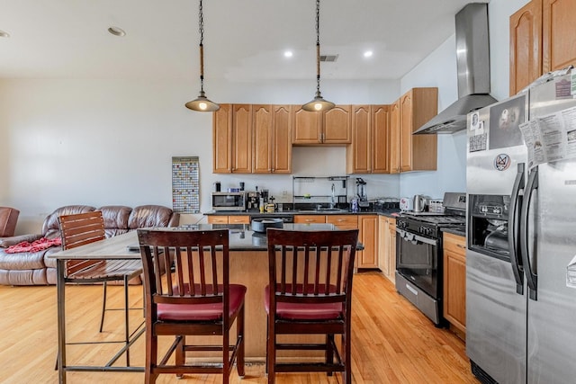 1918 W Cermak Rd Unit 4, Chicago, IL 60608 - kitchen featuring stainless steel appliances, wall chimney range hood, a center island, light wood-style flooring, and dark countertops