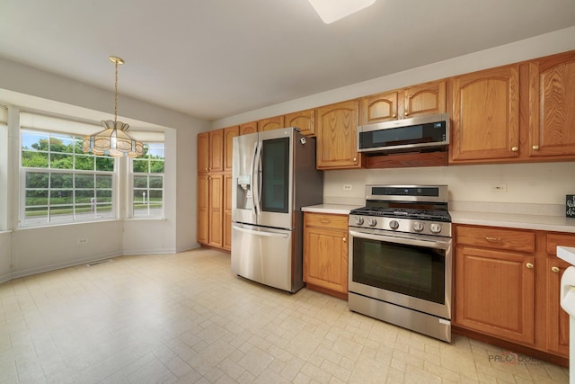 707 Wedgewood Trl, Mchenry, IL 60050 - kitchen with stainless steel appliances, light countertops, pendant lighting, a chandelier, and brown cabinets