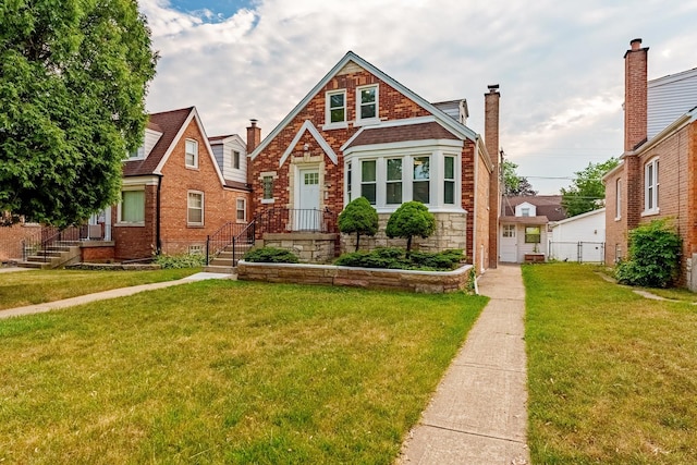 3020 77th Ave, Elmwood Park, IL 60707 - tudor home with a chimney, a front lawn, stone siding, and brick siding