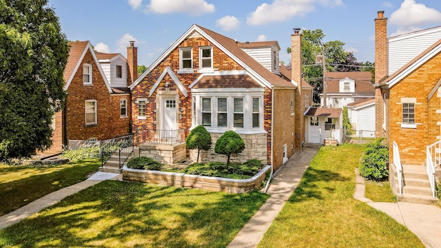 3020 77th Ave, Elmwood Park, IL 60707 - view of front of home featuring a front yard, a chimney, brick siding, and stone siding