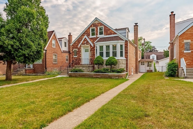 3020 77th Ave, Elmwood Park, IL 60707 - tudor-style house featuring a chimney, stone siding, and brick siding