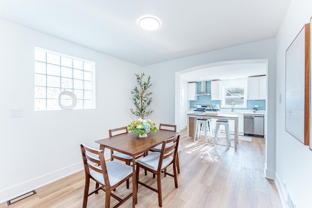 3020 77th Ave, Elmwood Park, IL 60707 - dining area featuring light wood finished floors and arched walkways