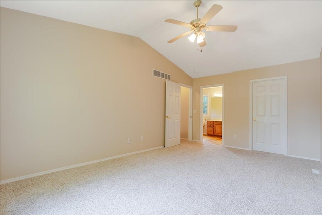3310 Stonebridge Dr, Bloomington, IL 61704 - unfurnished bedroom featuring light carpet, vaulted ceiling, ensuite bath, and a ceiling fan