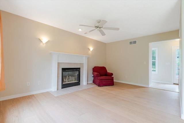 3310 Stonebridge Dr, Bloomington, IL 61704 - unfurnished room featuring light wood-style flooring, a fireplace, and ceiling fan