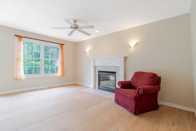 3310 Stonebridge Dr, Bloomington, IL 61704 - living area featuring light wood-type flooring, a ceiling fan, and a fireplace