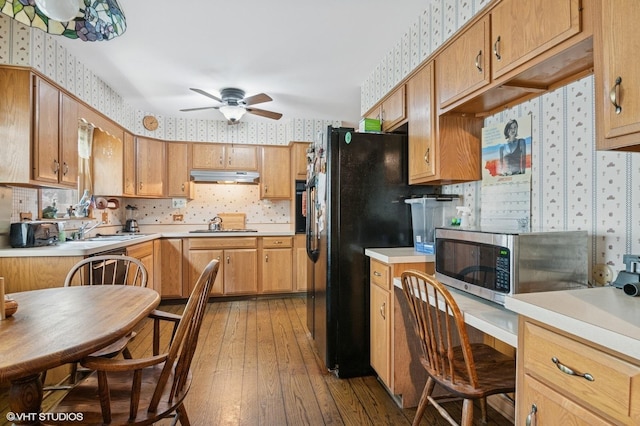 1615 E Miner St, Arlington Heights, IL 60004 - kitchen featuring wallpapered walls, black appliances, under cabinet range hood, ceiling fan, and hardwood / wood-style floors