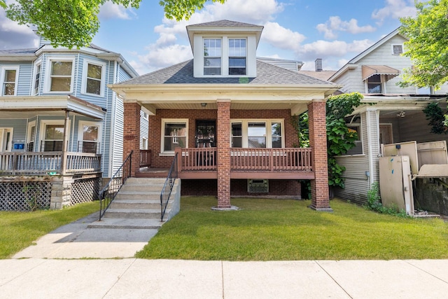 7807 S Burnham Ave, Chicago, IL 60649 - view of front of property with a porch, a shingled roof, a front yard, and brick siding