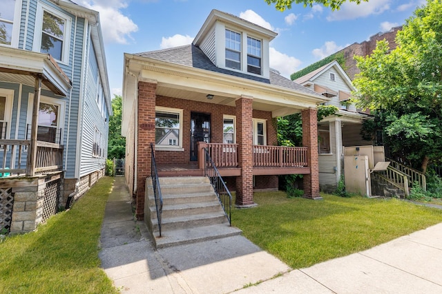 7807 S Burnham Ave, Chicago, IL 60649 - view of front of property featuring covered porch, brick siding, a front lawn, and a shingled roof