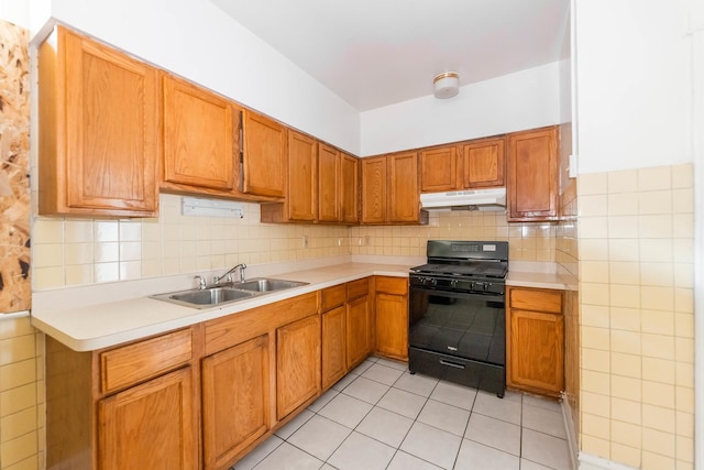 7807 S Burnham Ave, Chicago, IL 60649 - kitchen featuring black range with gas stovetop, under cabinet range hood, light countertops, and decorative backsplash
