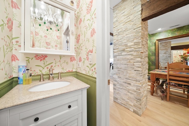 1530 W Monroe St, Chicago, IL 60607 - bathroom with wallpapered walls, wainscoting, vanity, and wood finished floors