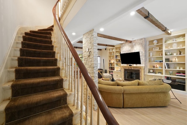 1530 W Monroe St, Chicago, IL 60607 - living area featuring decorative columns, beam ceiling, light wood-style flooring, a stone fireplace, and stairway