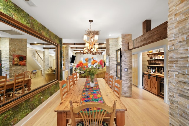 1530 W Monroe St, Chicago, IL 60607 - dining room featuring light wood finished floors, a chandelier, a dry bar, stairs, and a fireplace