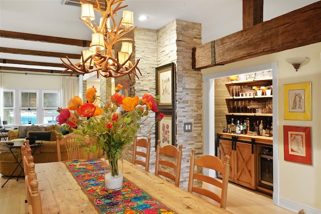 1530 W Monroe St, Chicago, IL 60607 - dining space featuring a chandelier, light wood-type flooring, a bar, and beam ceiling