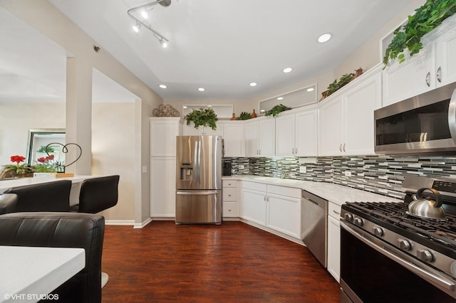 3125 Town Square Dr Unit 408, Rolling Meadows, IL 60008 - kitchen featuring stainless steel appliances, light countertops, dark wood-type flooring, decorative backsplash, and white cabinetry