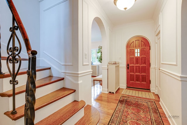 670 S Green Bay Rd, Lake Forest, IL 60045 - foyer with light wood-type flooring, arched walkways, and stairway