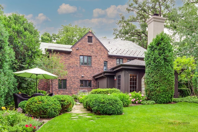 670 S Green Bay Rd, Lake Forest, IL 60045 - rear view of house with a lawn, a chimney, and brick siding