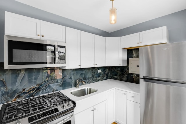 4880 N Marine Dr Unit 404, Chicago, IL 60640 - kitchen with stainless steel appliances, white cabinetry, light countertops, and decorative backsplash