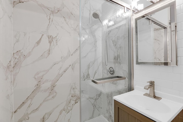 4880 N Marine Dr Unit 404, Chicago, IL 60640 - bathroom featuring vanity, a marble finish shower, and tile walls