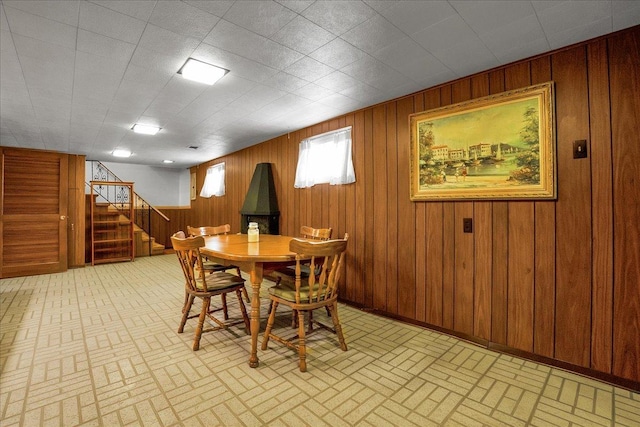 11340 S Drake Ave, Chicago, IL 60655 - dining area featuring brick patterned floors, stairway, and wooden walls