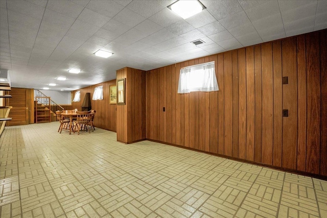 11340 S Drake Ave, Chicago, IL 60655 - below grade area featuring brick patterned flooring, stairs, and wood walls