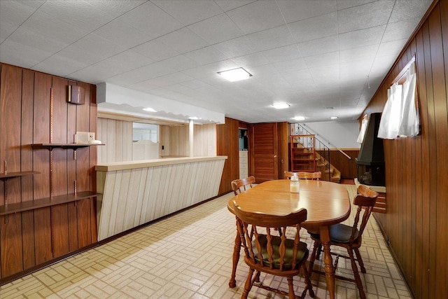 11340 S Drake Ave, Chicago, IL 60655 - dining space with wood walls, brick patterned flooring, and stairway