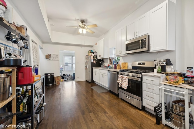 2076 N Campbell Ave, Chicago, IL 60647 - kitchen with stainless steel appliances, a ceiling fan, white cabinetry, dark wood-type flooring, and beverage cooler