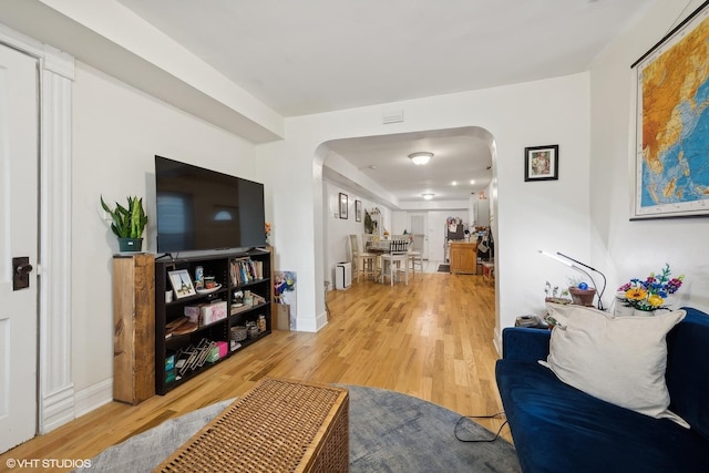 2076 N Campbell Ave, Chicago, IL 60647 - living area with arched walkways and light wood-style floors