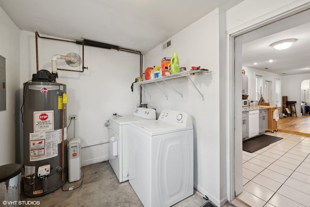 2076 N Campbell Ave, Chicago, IL 60647 - laundry room with gas water heater, washing machine and dryer, and light tile patterned flooring