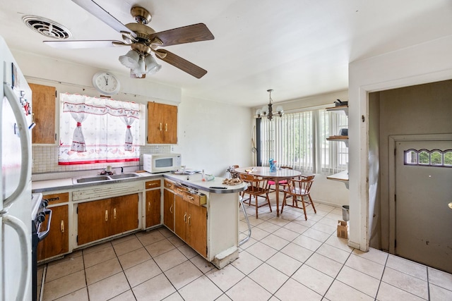 15620 Ingleside Ave, Dolton, IL 60419 - kitchen with white appliances, decorative backsplash, brown cabinetry, and a chandelier