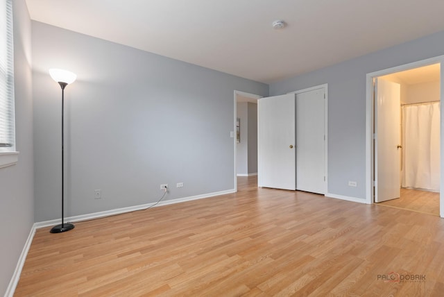 557 E Shag Bark Ln Unit H, Streamwood, IL 60107 - unfurnished bedroom with light wood-style floors and baseboards