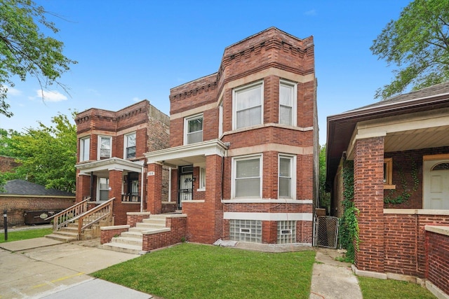 1516 E 74th Pl, Chicago, IL 60619 - view of front facade with brick siding and a front lawn