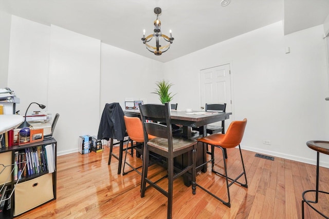 1516 E 74th Pl, Chicago, IL 60619 - dining area with a chandelier and light wood-style floors
