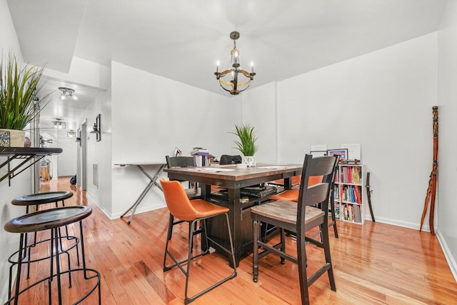 1516 E 74th Pl, Chicago, IL 60619 - dining room featuring light wood-type flooring, a chandelier, and a desk