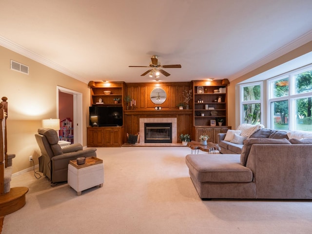 15955 Raintree Rd, Bloomington, IL 61705 - living area with ornamental molding, a ceiling fan, a fireplace, built in shelves, and carpet