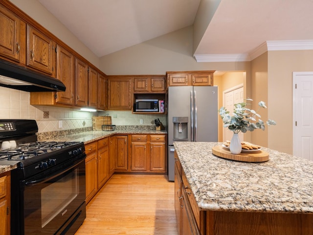 15955 Raintree Rd, Bloomington, IL 61705 - kitchen featuring stainless steel appliances, light wood-style floors, under cabinet range hood, brown cabinetry, and light stone countertops