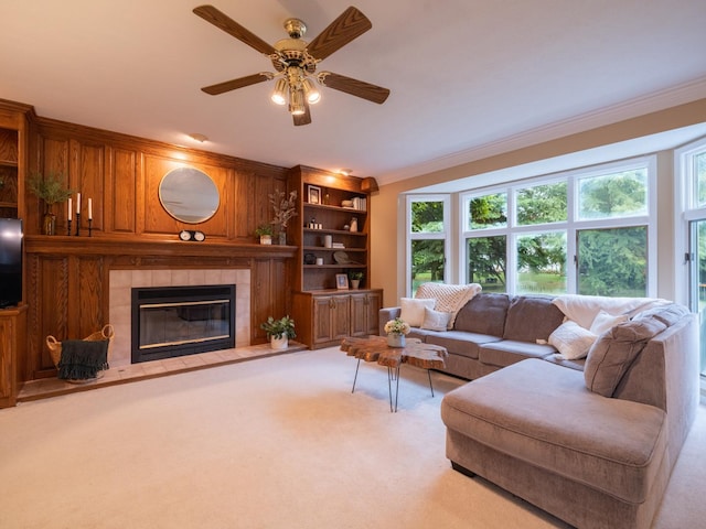 15955 Raintree Rd, Bloomington, IL 61705 - carpeted living area with healthy amount of natural light, crown molding, a fireplace, and ceiling fan