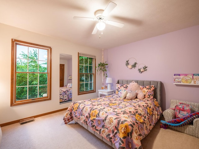 15955 Raintree Rd, Bloomington, IL 61705 - carpeted bedroom with multiple windows and a ceiling fan