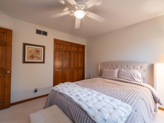 15955 Raintree Rd, Bloomington, IL 61705 - bedroom featuring light carpet, a closet, and ceiling fan