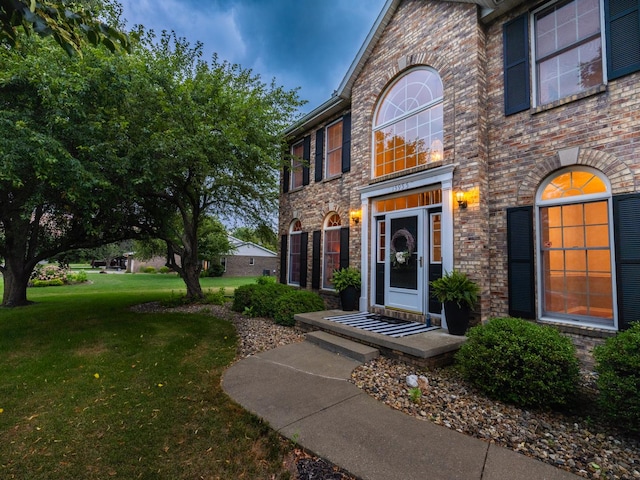 15955 Raintree Rd, Bloomington, IL 61705 - doorway to property with a yard and brick siding