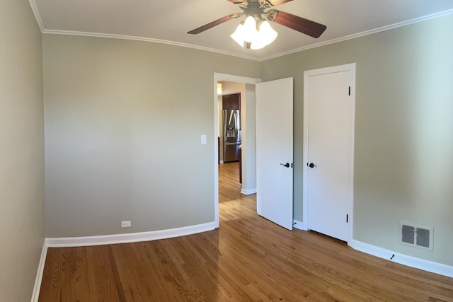 7641 W Hortense Ave, Chicago, IL 60631 - unfurnished bedroom with stainless steel fridge with ice dispenser, wood finished floors, crown molding, and ceiling fan
