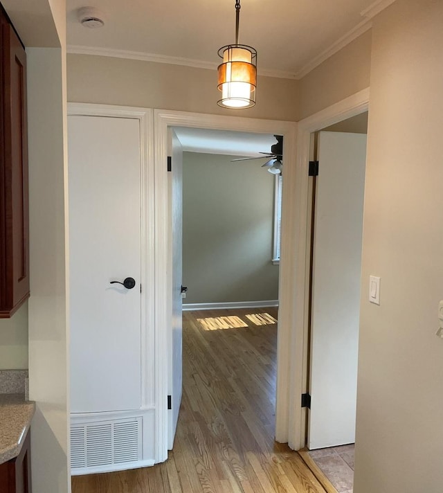 7641 W Hortense Ave, Chicago, IL 60631 - corridor featuring light wood-type flooring and crown molding