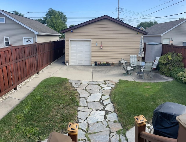 7641 W Hortense Ave, Chicago, IL 60631 - fenced backyard with an outbuilding, driveway, a detached garage, and a patio area
