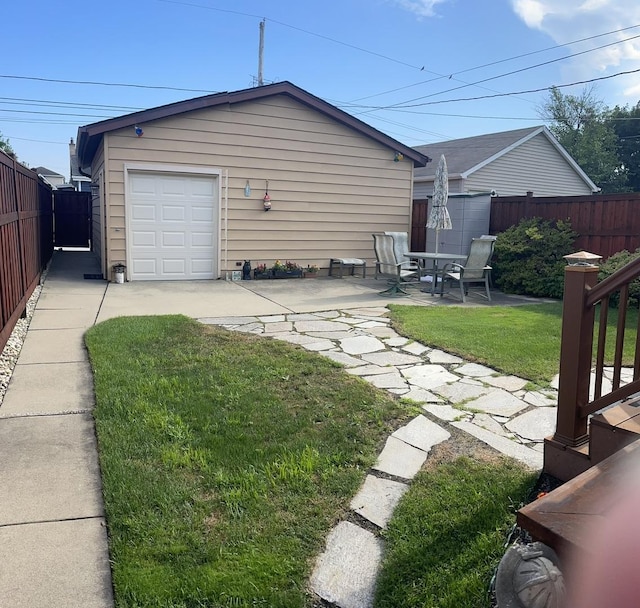 7641 W Hortense Ave, Chicago, IL 60631 - back of house featuring driveway, a patio area, and a garage