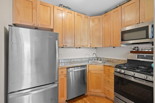 4240 N Clarendon Ave Unit 405S, Chicago, IL 60613 - kitchen with appliances with stainless steel finishes, light wood-style flooring, light brown cabinets, and light stone counters
